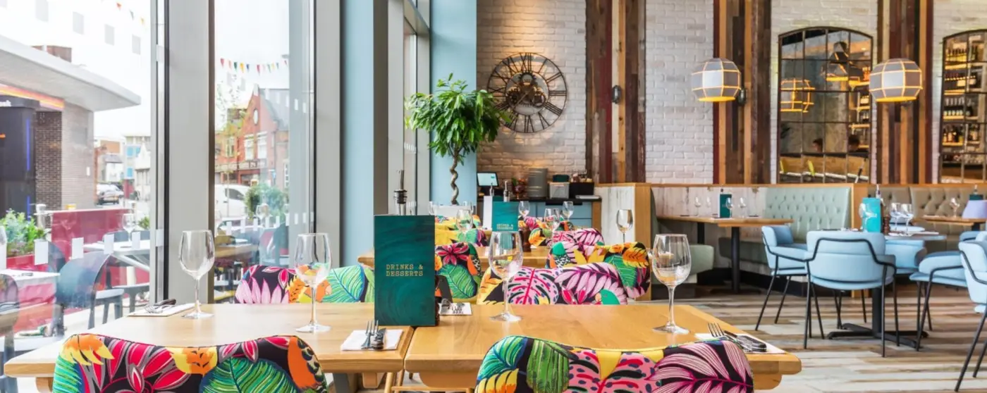 Inside the dining area at Wildwood Hinckley restaurant, showing table seating options, contemporary interior design, and restaurant decor for family dining