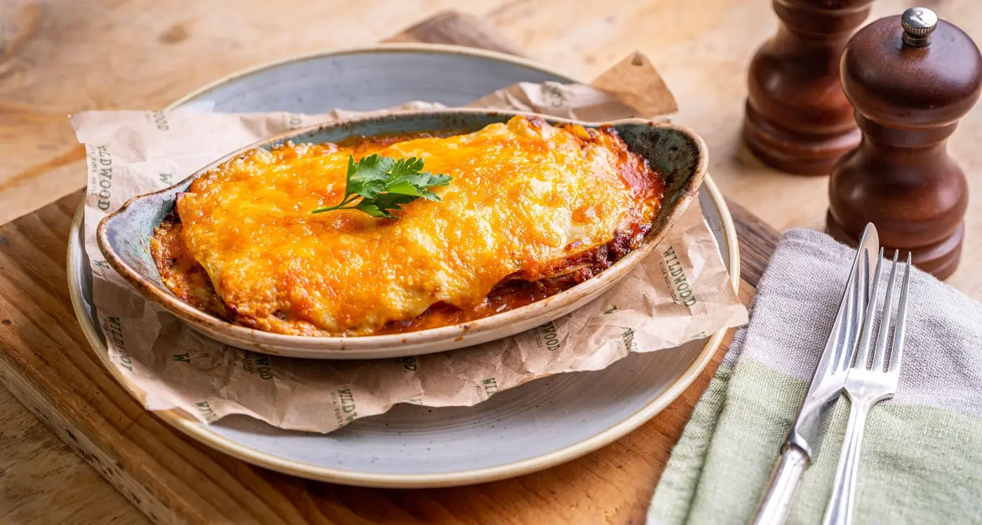 Wildwood Restaurants lasagne rich beef ragù, layered pasta, topped with a creamy béchamel sauce and cheese