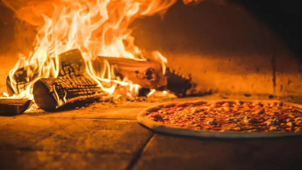 Wildwood Restaurants stone-baked pizza oven with pizza cooking inside