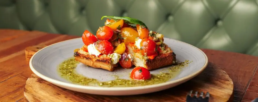 Tomato and ricotta bruschetta with red pepper tapenade on grilled focaccia from the Wildwood restaurant menu