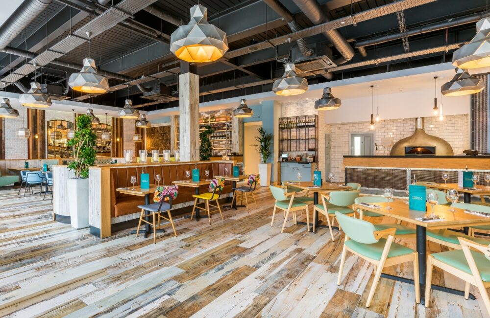 Spacious dining area and open kitchen layout at Wildwood Hinckley pizza pasta grill restaurant, featuring family-friendly table seating