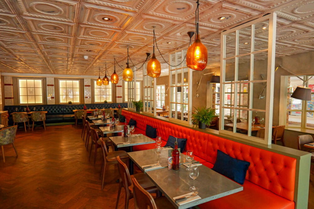 Modern interior dining room at Wildwood Salisbury pizza pasta grill restaurant, featuring spacious table seating for lunch or dinner dates.